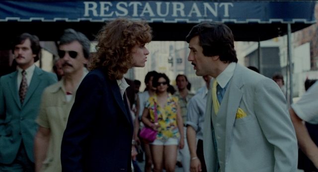 Wide shot frame from The King of Comedy — walking, dialogue, street