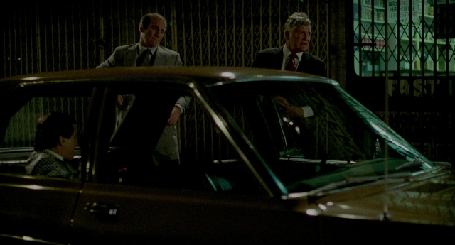 Wide shot frame from The King of Comedy — sitting, standing, room