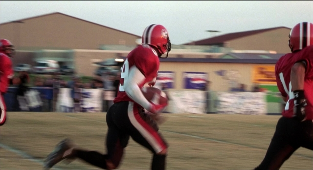 Wide shot frame from The New Guy — hat, hand, person