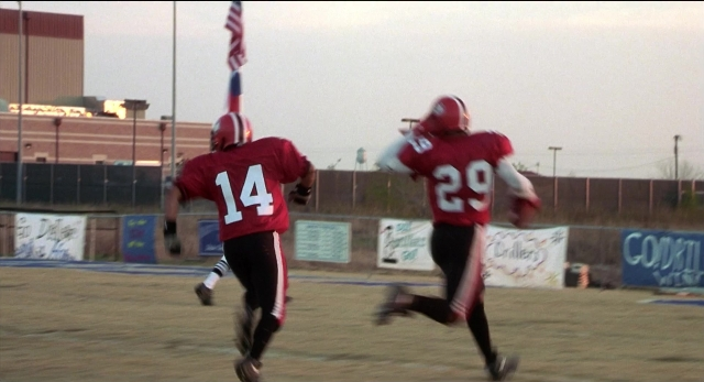 Wide shot frame from The New Guy — person, footwear, running