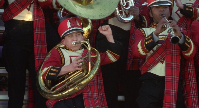 Medium shot frame from The New Guy — standing, horn, person