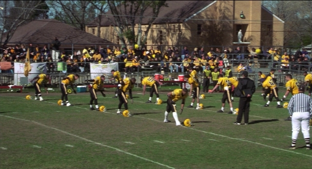 Wide shot frame from The New Guy — standing, person, football helmet
