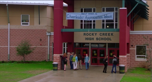 Wide shot frame from The New Guy — standing, door, person