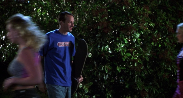 Wide shot frame from The New Guy — standing, walking, hand