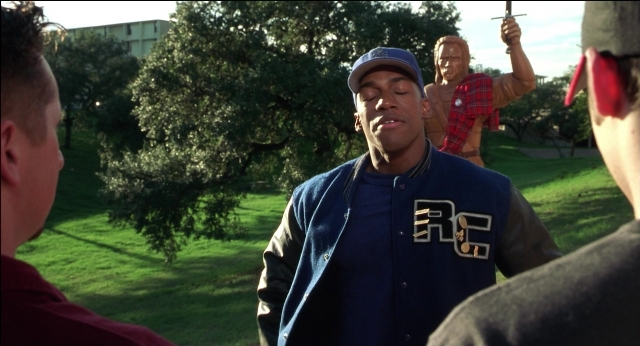 Wide shot frame from The New Guy — standing, hat, face