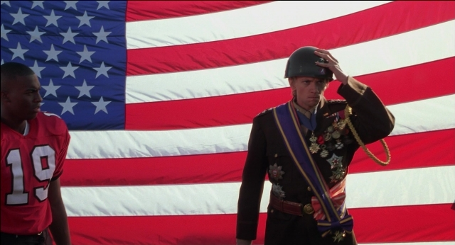 Wide shot frame from The New Guy — standing, hat, uniform