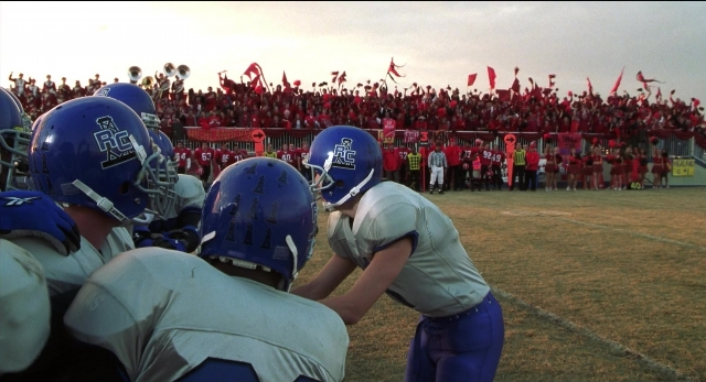 Wide shot frame from The New Guy — person, football helmet