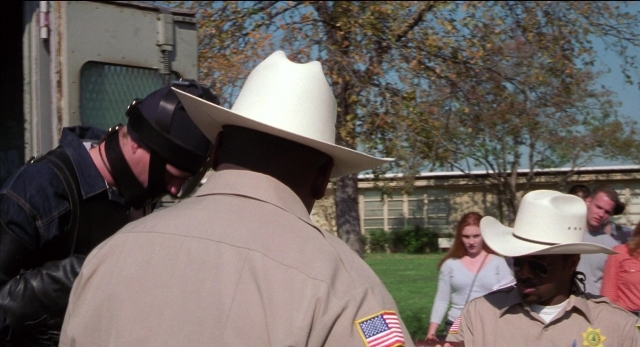 Wide shot frame from The New Guy — standing, hat, uniform