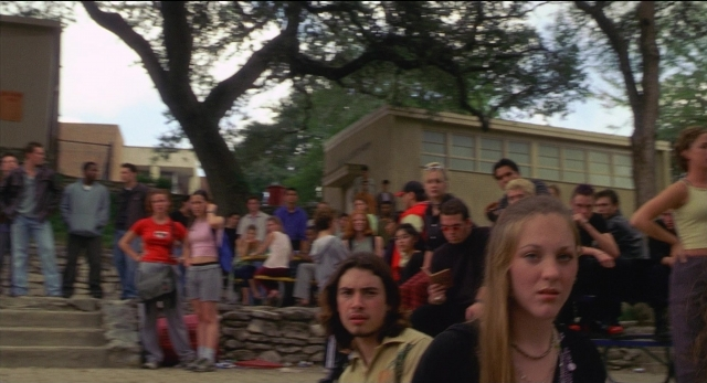 Wide shot frame from The New Guy — sitting, standing, dialogue