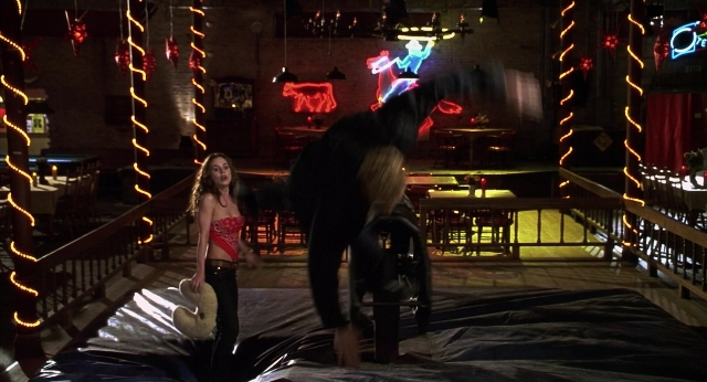 Wide shot frame from The New Guy — standing, room, hand