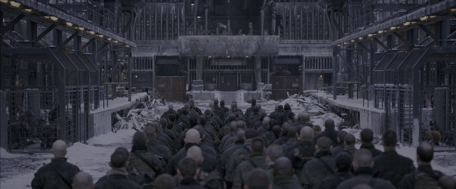 Wide shot frame from War for the Planet of the Apes — standing, room, person