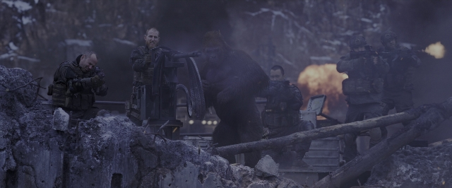 Wide shot frame from War for the Planet of the Apes — standing, hat, gun