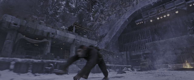 Wide shot frame from War for the Planet of the Apes — walking, fire, snow