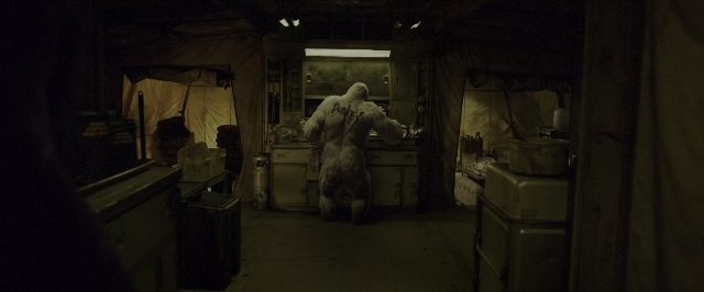 Wide shot frame from War for the Planet of the Apes — standing, room, door