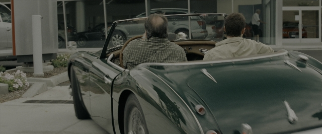 Wide shot frame from Transformers — sitting, walking, car