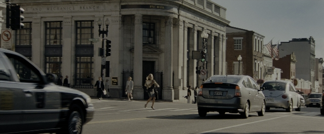 Wide shot frame from Transformers — walking, street, car