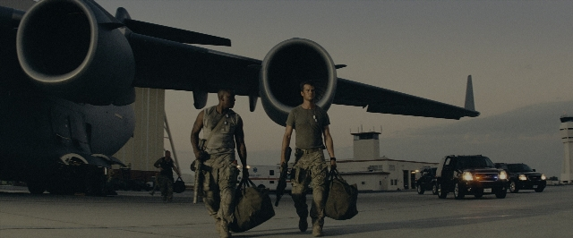 Wide shot frame from Transformers — walking, car, airplane