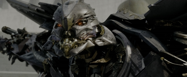 Wide shot frame from Transformers — hat, face, person