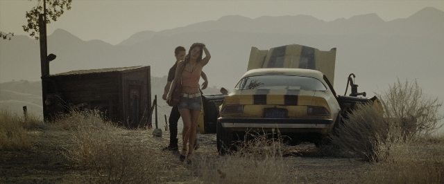 Wide shot frame from Transformers — standing, street, car