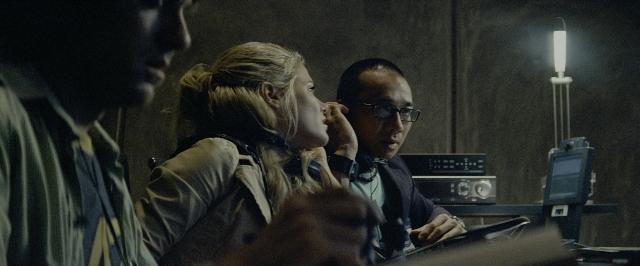 Wide shot frame from Transformers — sitting, room, dialogue
