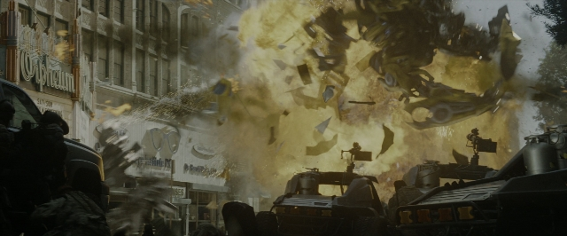 Wide shot frame from Transformers — street, car, smoke