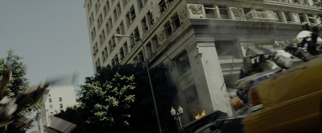 Wide shot frame from Transformers — street, car, water