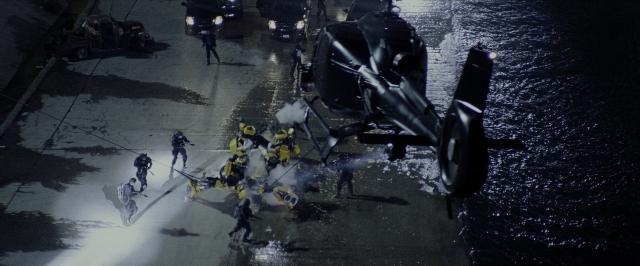 Wide shot frame from Transformers — standing, street, night