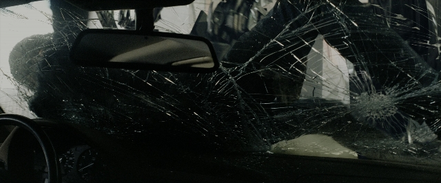 Wide shot frame from Transformers — street, mirror, car