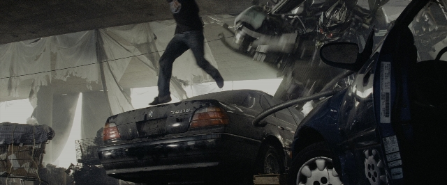 Wide shot frame from Transformers — plate, car, shirt