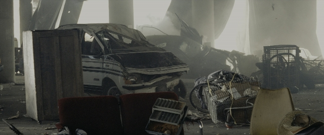 Wide shot frame from Transformers — car, chair, smoke