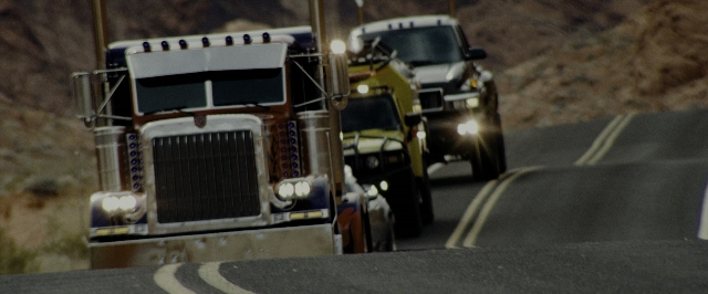 Wide shot frame from Transformers — street, truck, wheel