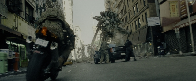 Wide shot frame from Transformers — walking, plate, street