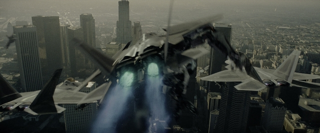 Wide shot frame from Transformers — skyscraper, smoke