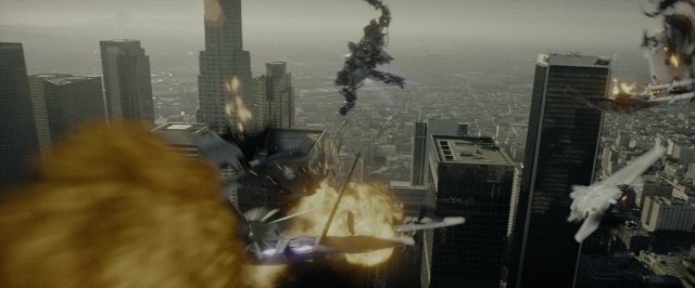 Wide shot frame from Transformers — skyscraper, smoke