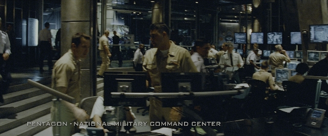Wide shot frame from Transformers — room, person, human face