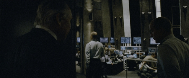 Wide shot frame from Transformers — sitting, standing, room