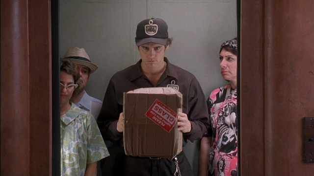 Wide shot frame from Ace Ventura: Pet Detective — standing, door, hat