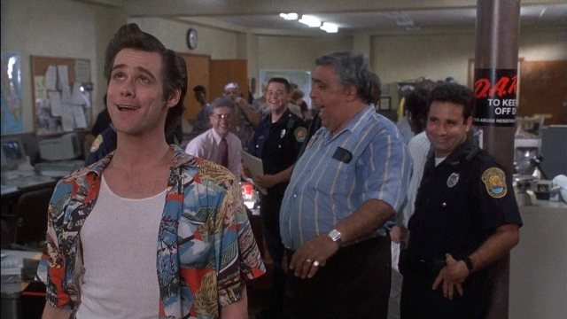 Wide shot frame from Ace Ventura: Pet Detective — dialogue, uniform, shirt