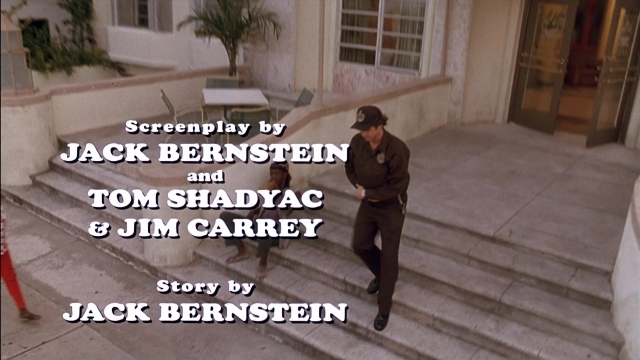 Wide shot frame from Ace Ventura: Pet Detective — walking, table, hat