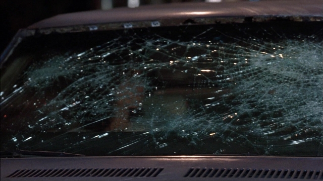 Wide shot frame from Ace Ventura: Pet Detective — street, car, night