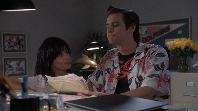 Frame from Ace Ventura: Pet Detective — sitting, hand, shirt