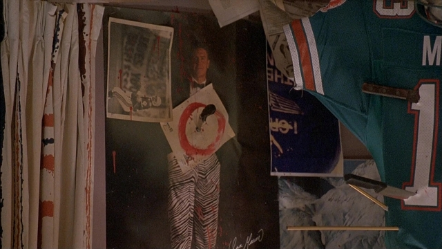 Wide shot frame from Ace Ventura: Pet Detective — standing, room, suit
