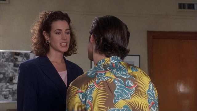Wide shot frame from Ace Ventura: Pet Detective — room, dialogue, door