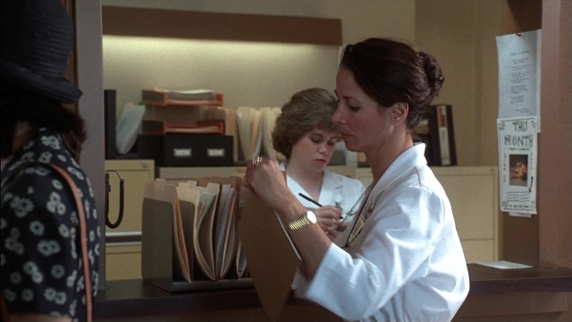 Wide shot frame from Ace Ventura: Pet Detective — standing, room, hat