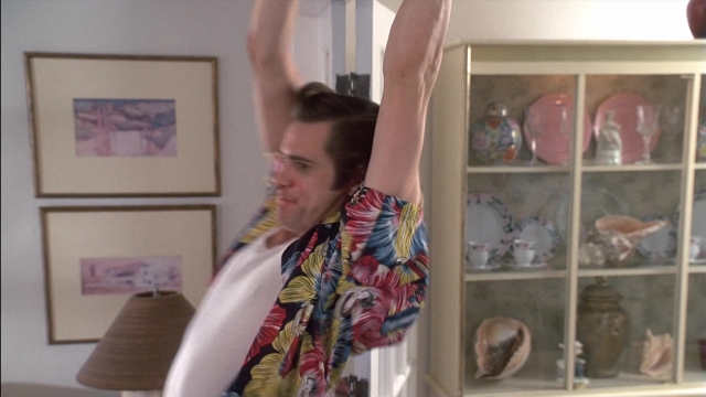 Frame from Ace Ventura: Pet Detective — standing, room, shirt