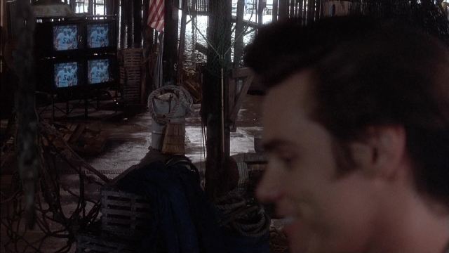 Wide shot frame from Ace Ventura: Pet Detective — room, hat, face