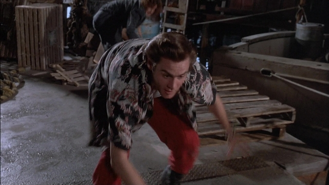 Wide shot frame from Ace Ventura: Pet Detective — standing, shirt, face