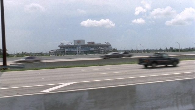 Frame from Ace Ventura: Pet Detective — street, car, wheel