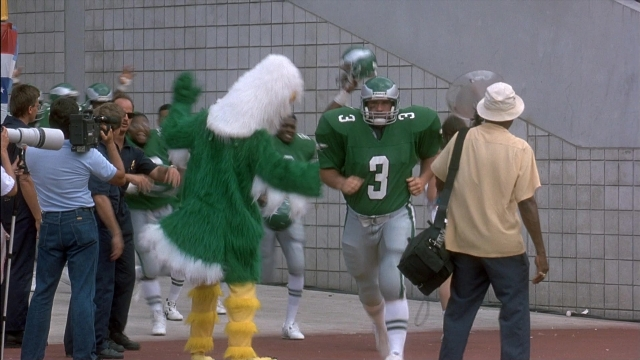 Wide shot frame from Ace Ventura: Pet Detective — standing, hat, person