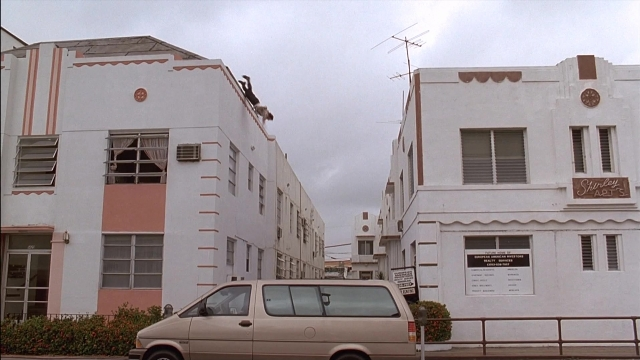 Frame from Ace Ventura: Pet Detective — street, house, van